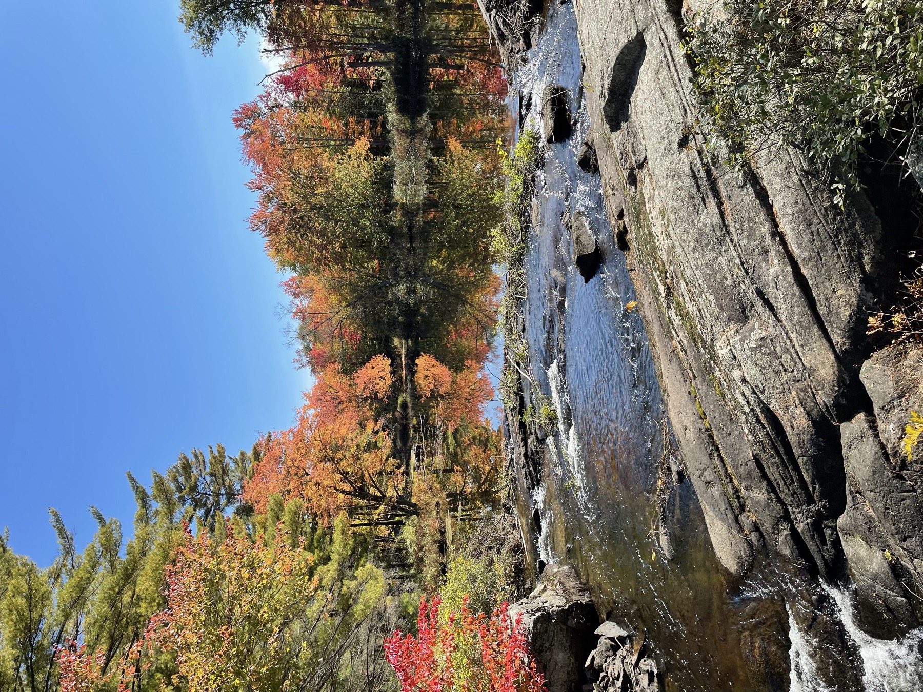 Muskoka Falls in autumn with brilliant foliage