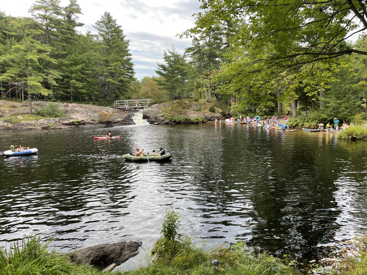 Families kayaking and tubing on the Kahshe River